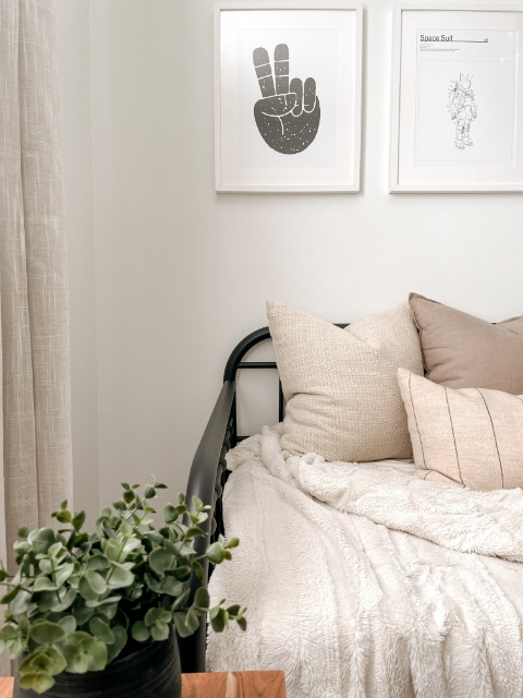A little boy's nursery with a wooden crib, white walls and a comfortable rocking chair.